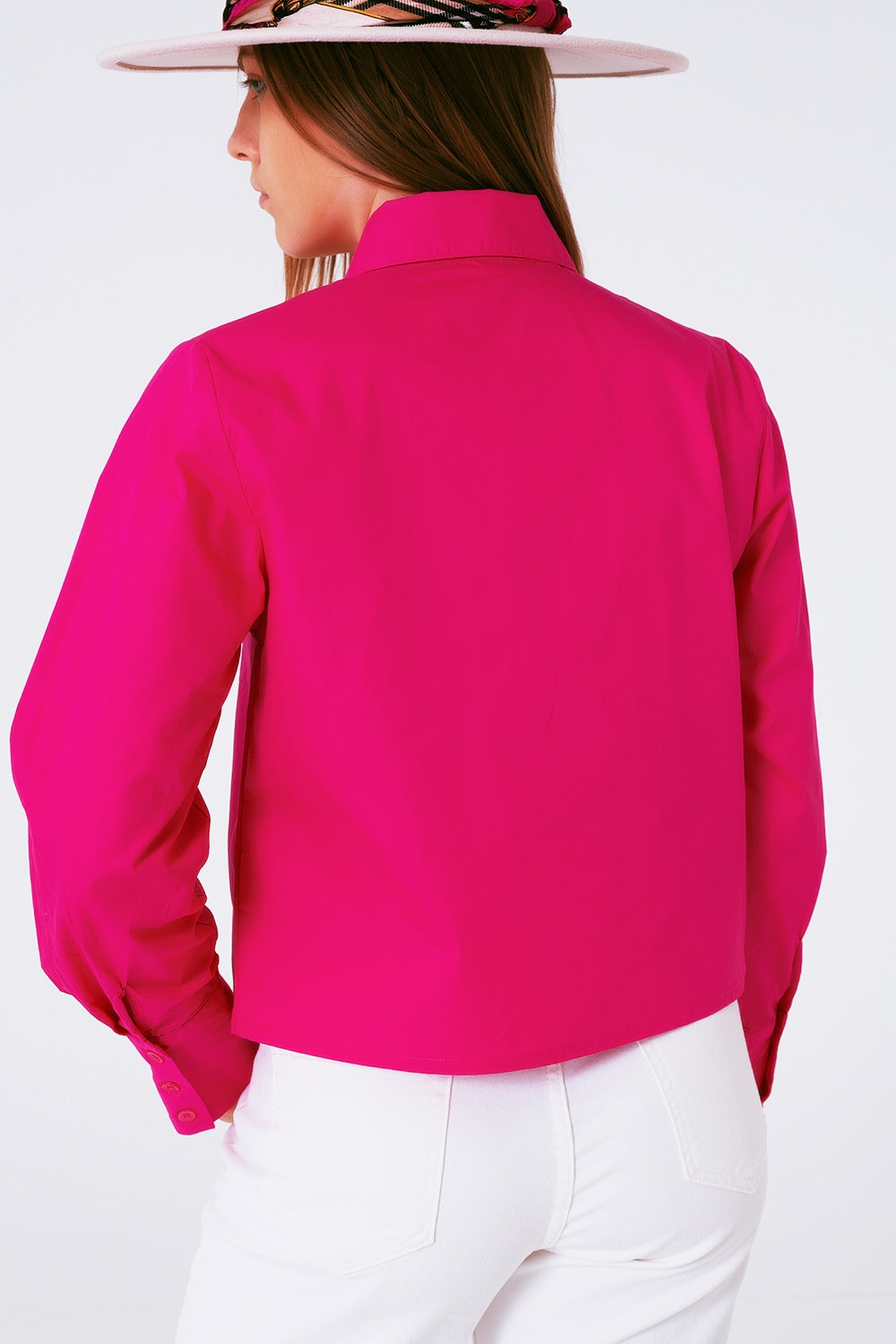 Vista trasera de una camisa de algodón en color fucsia de corte clásico.