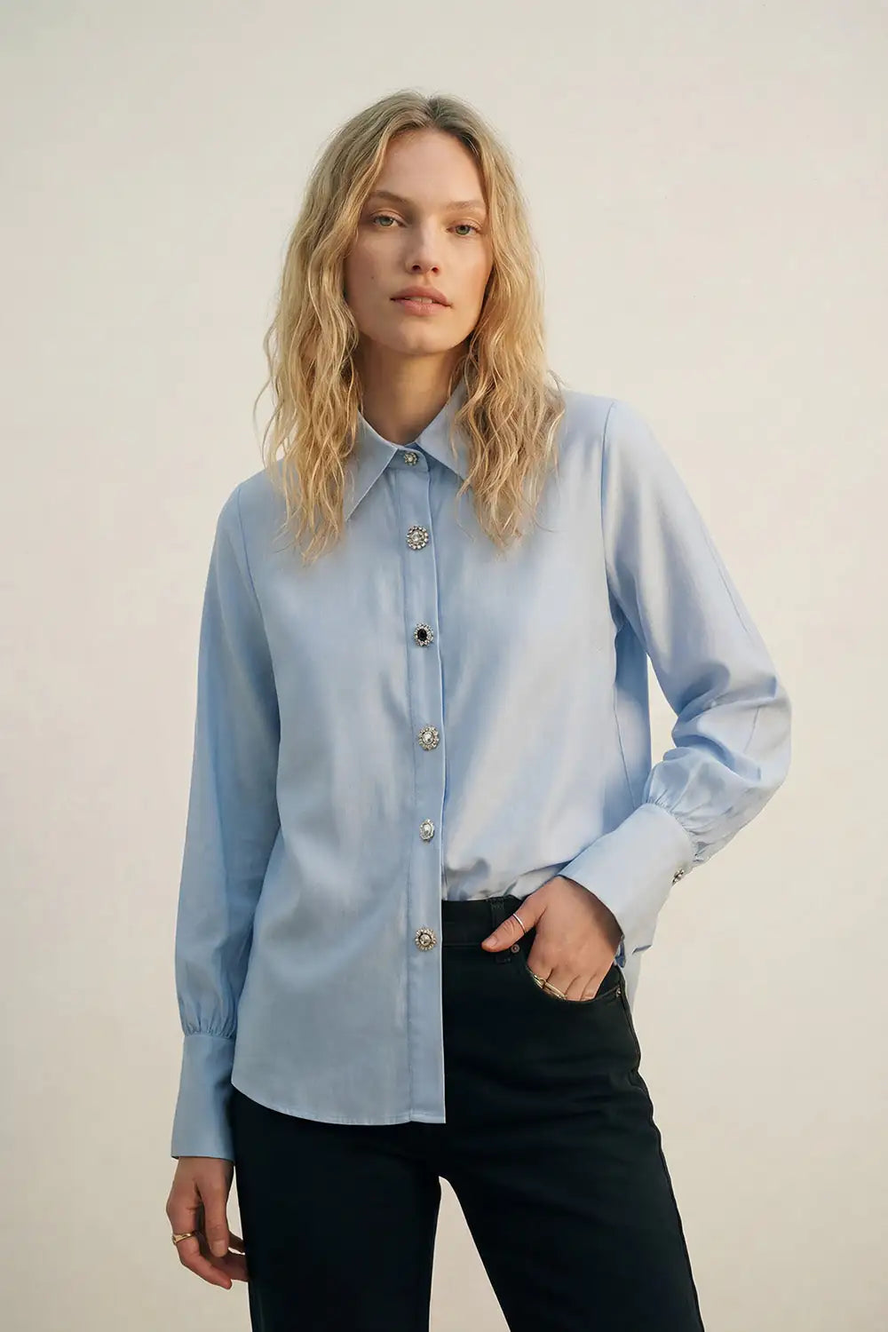 Camisa fluida de lyocell color azul claro con puños anchos y botones joya variados con cristales y zafiro azul.