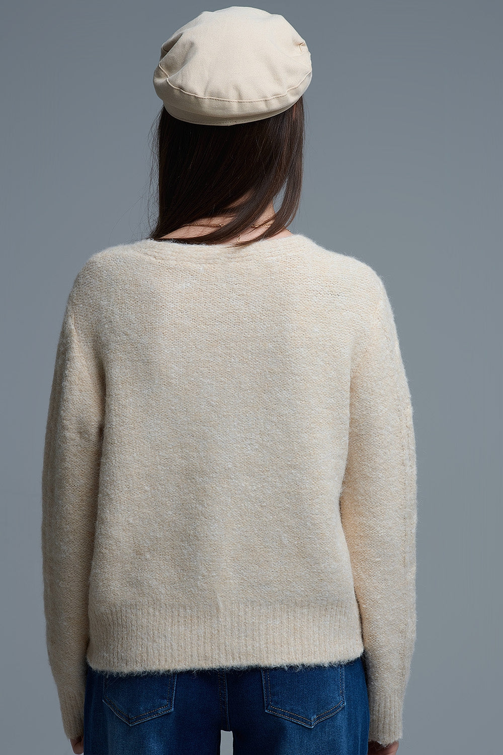 Chaqueta de punto beige con flores bordadas