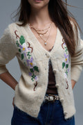 Chaqueta de punto beige con flores bordadas