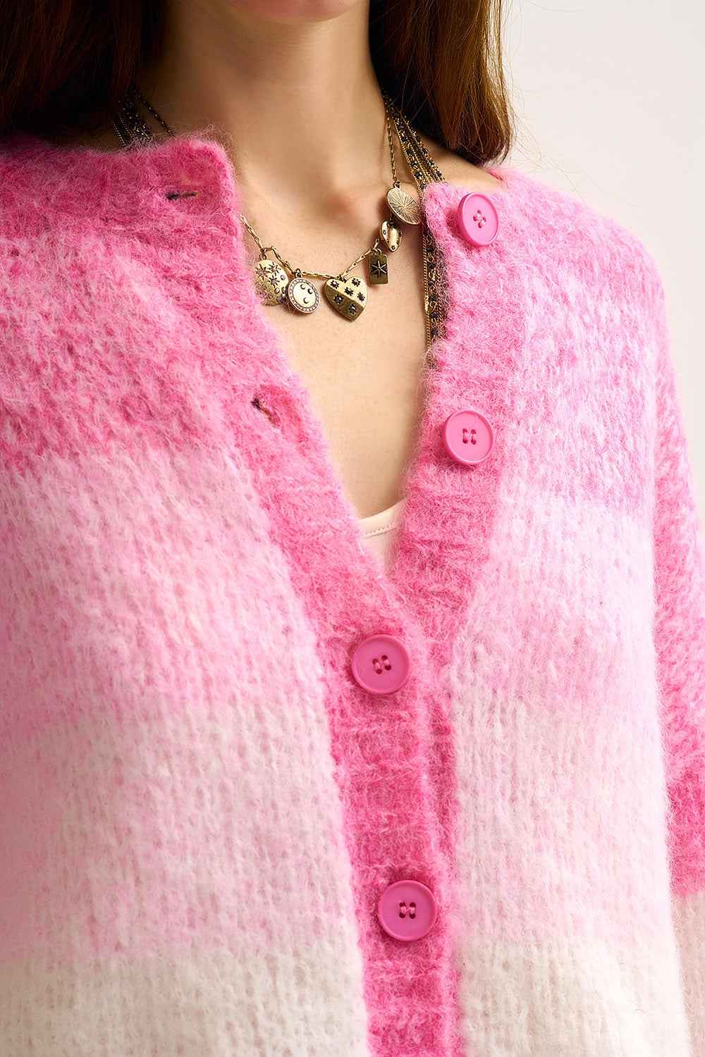 Chaqueta de punto grueso en degradado rosa con textura suave y botones delante