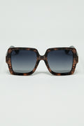 Gafas de sol con montura estampada marrón y patillas negras