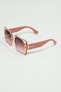 Gafas de sol cuadradas rosas con detalle dorado en el lateral