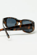 Gafas de sol ovaladas con montura transparente de alto brillo en marrón
