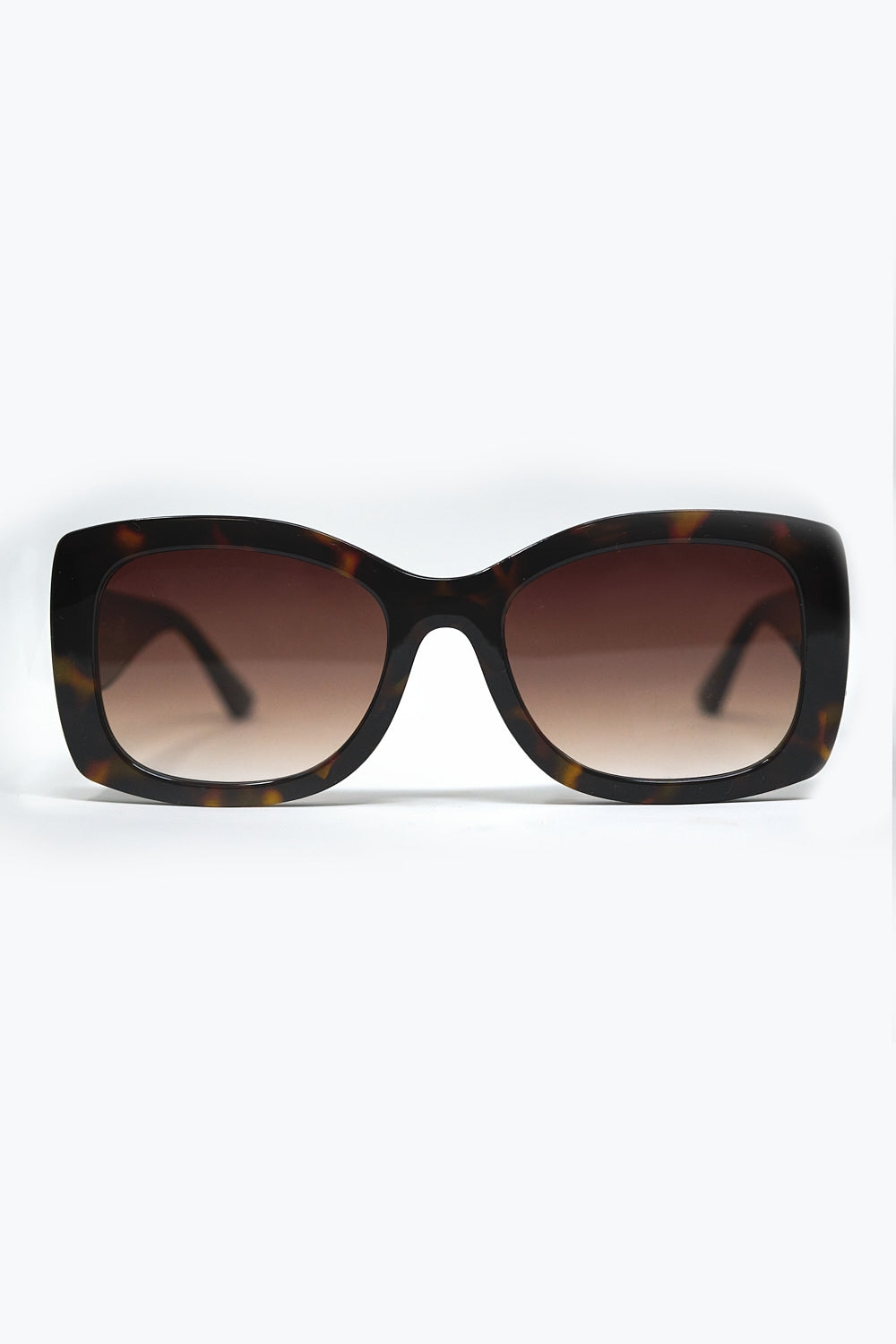 Gafas de sol ovaladas oversize con montura carey y cristales marrones degradados vista frontal.