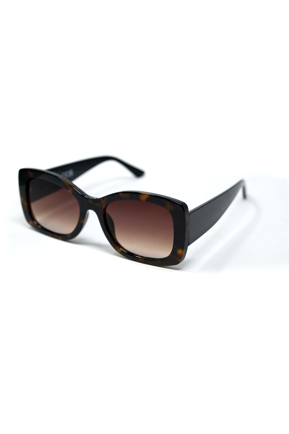 Gafas de sol ovaladas oversize con montura carey y cristales marrones degradados vista lateral.