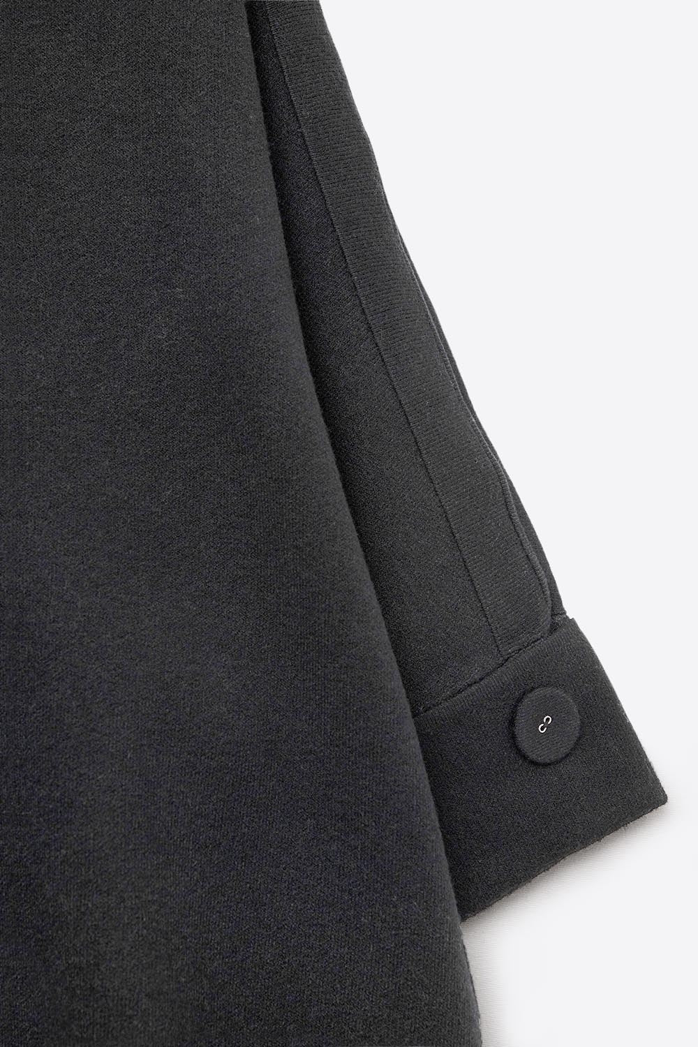 Jersey de punto negro con mangas Detalles de botones