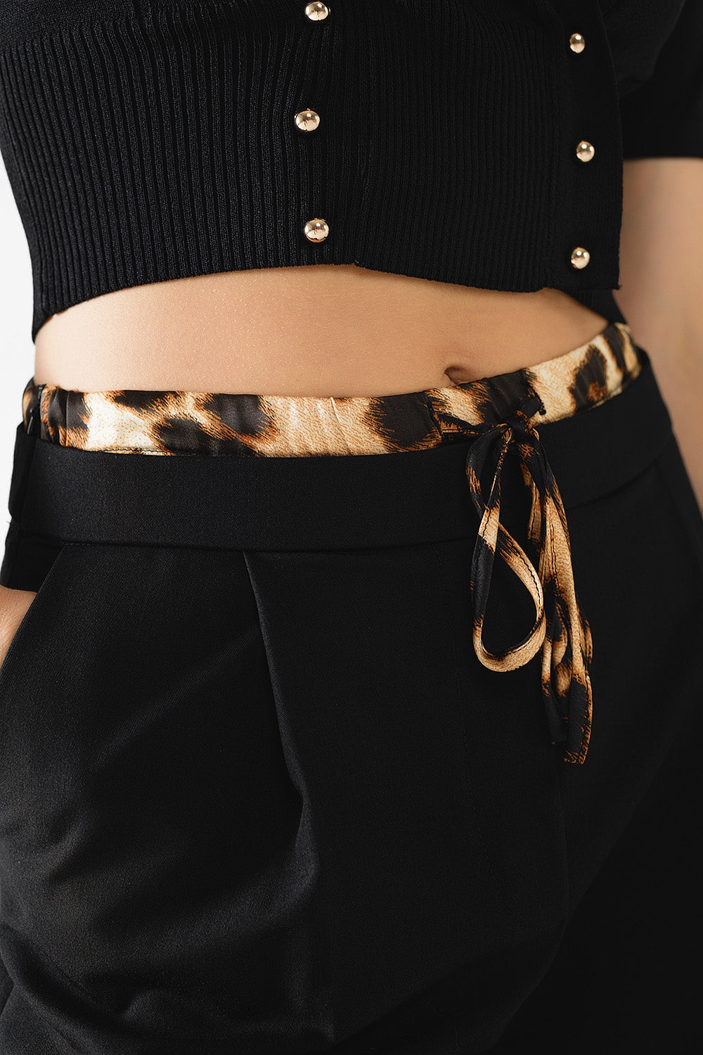 Pantalón largo negro plisado con detalle de leopardo en la cintura