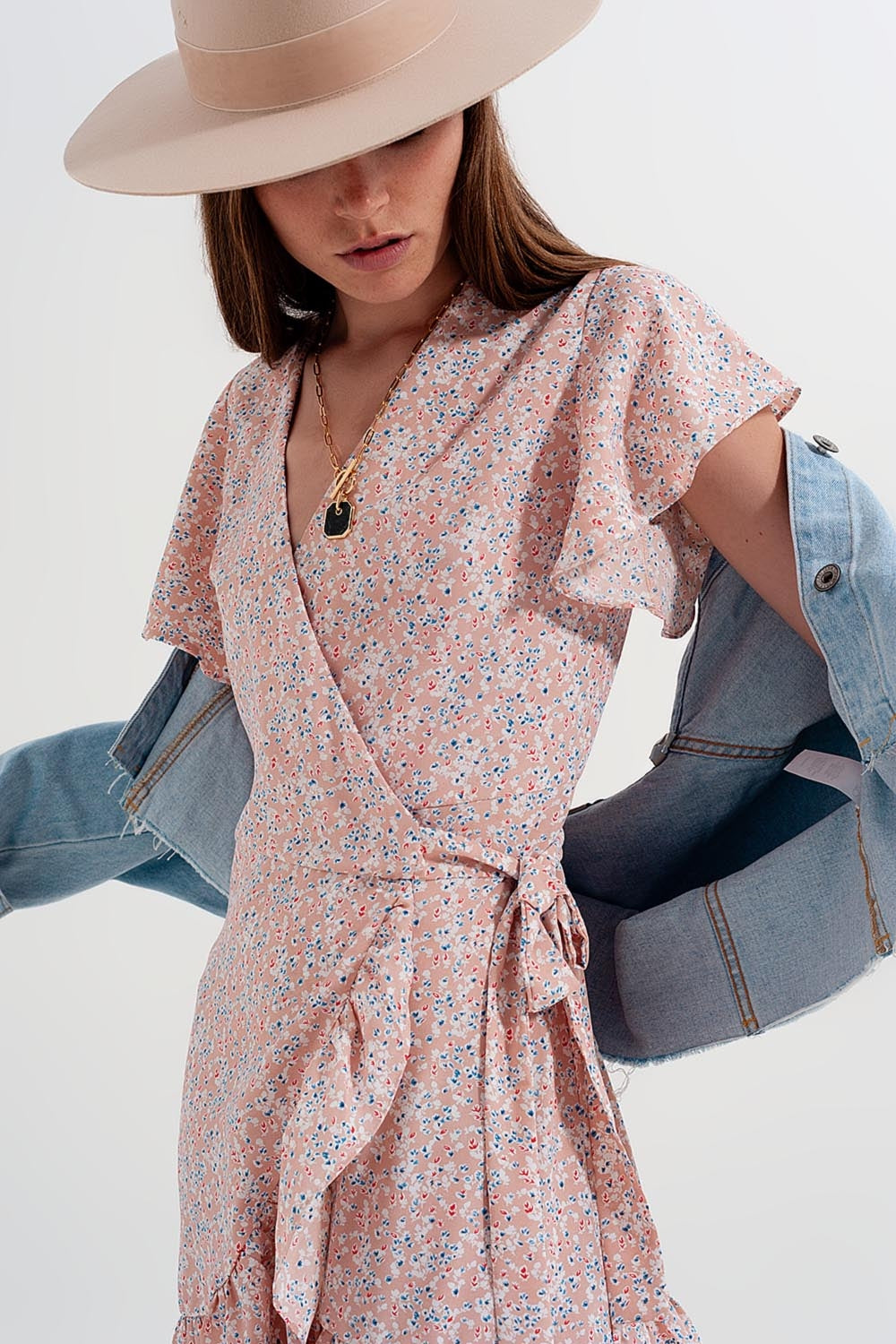 Vestido corto rosa cruzado con detalle de volantes y estampado de florecitas